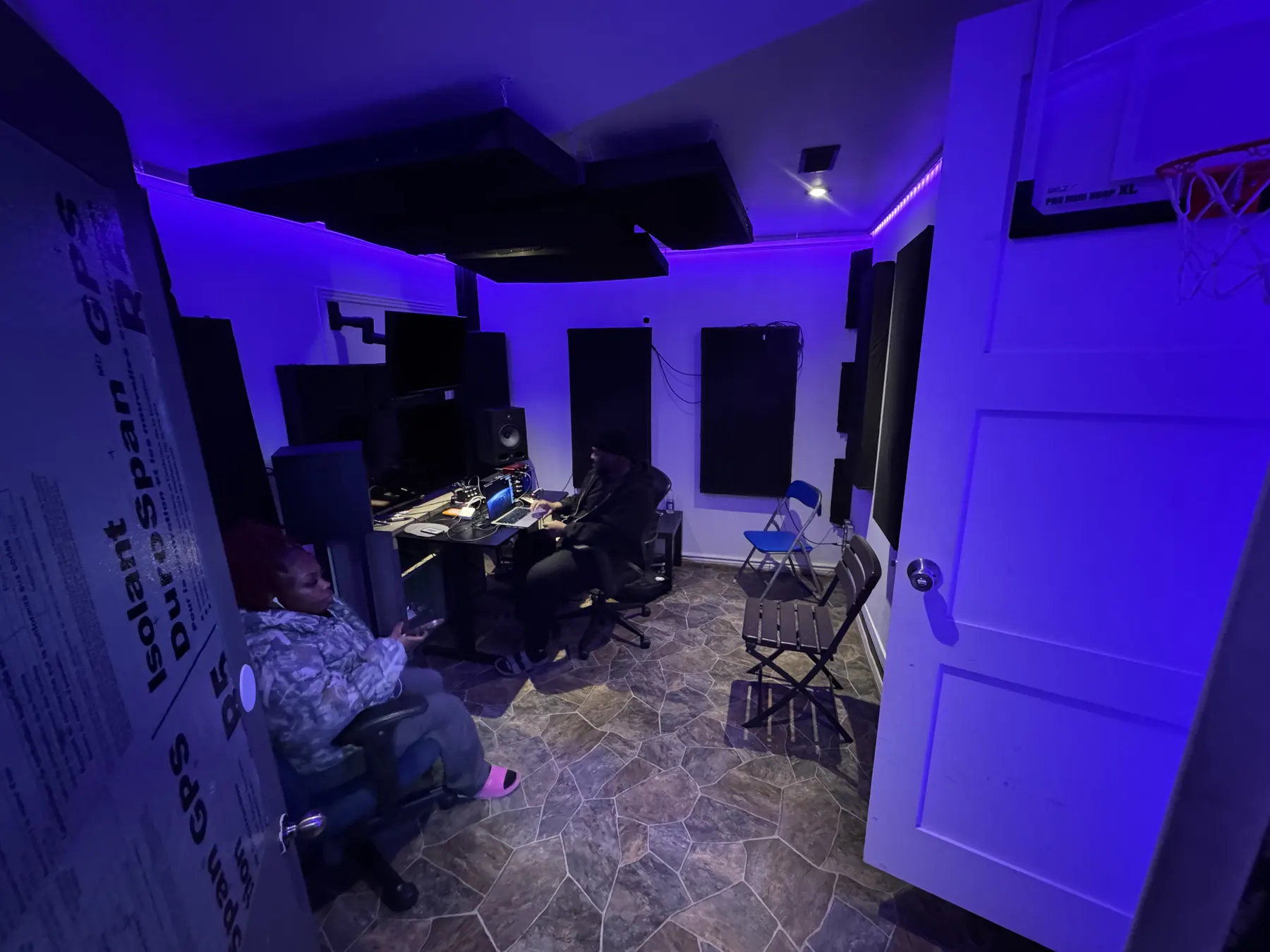 A C.A.U.S.E. recording studio room with purple lighting and studio equipment